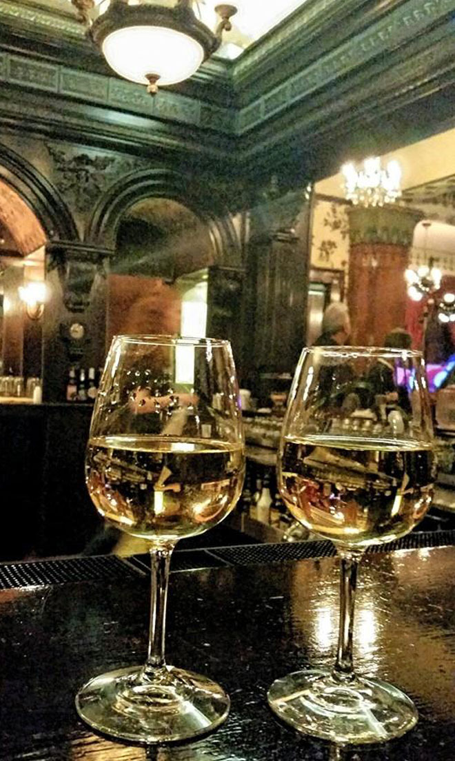 Wine glasses on bar at The Corinthian Event Center.