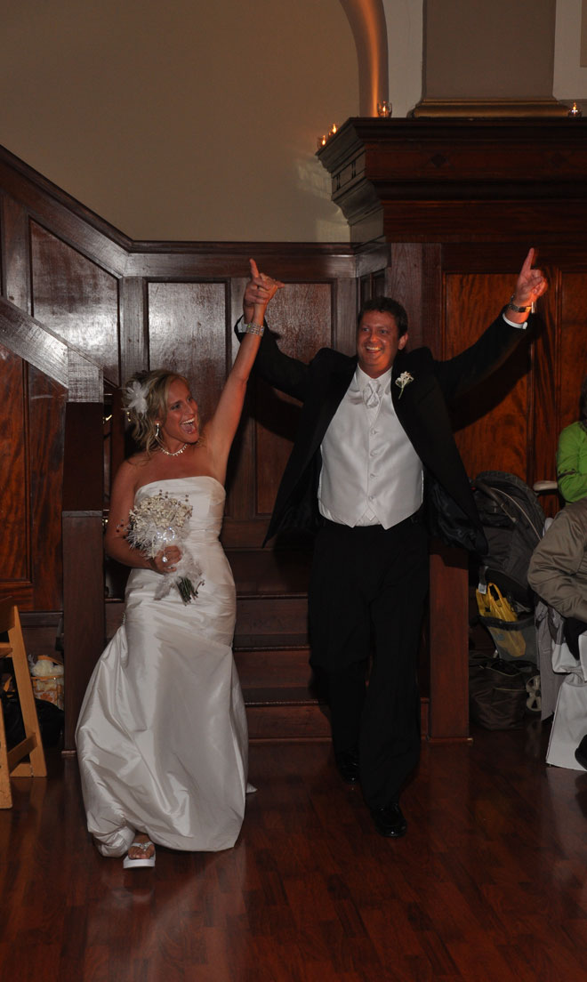 Bride and Groom celebrate in the entrance to the Grand Ballroom at The Corinthian Event Center.