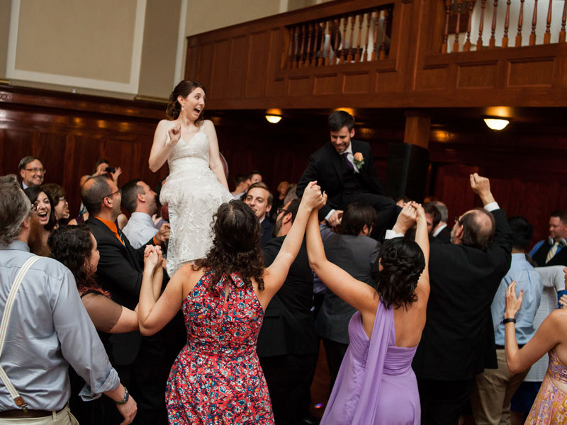 Bride and Groom and guests in chair dance at The Corinthian Event Center.