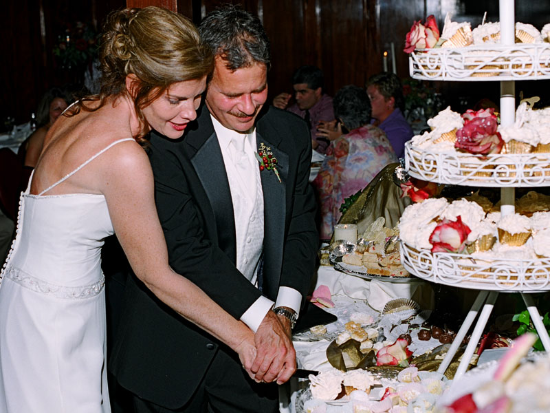 Bride and Groom cut cake at The Corinthian Event Center.