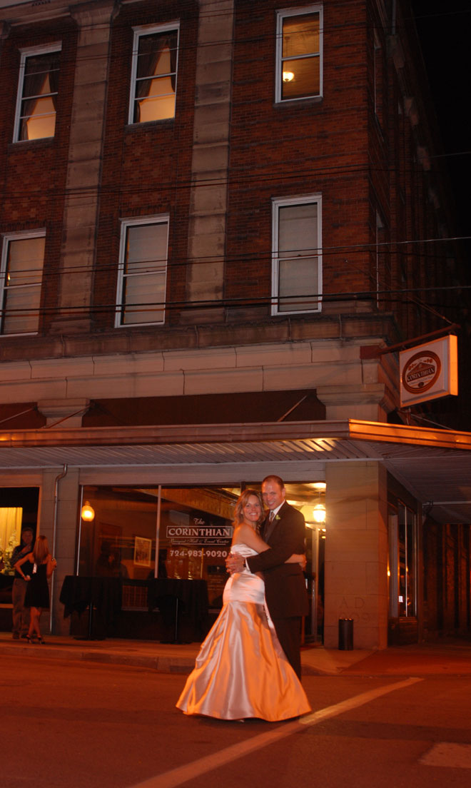 Bride and Groom on street in frunt of The Corinthian Event Center.