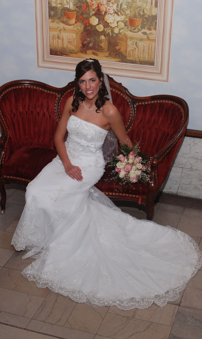 Bride on red soft in blue marble entrance at The Corinthian Event Center.