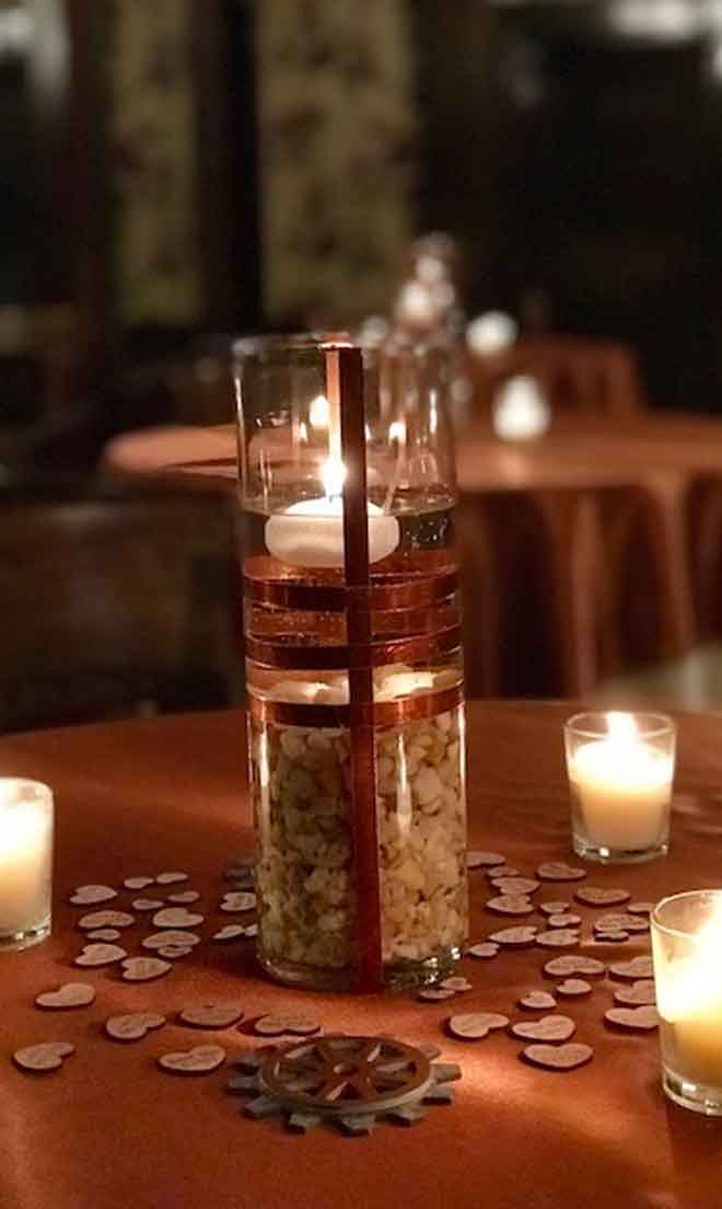 Lighted candle holder centerpiece decor at The Corinthian Event Center.
