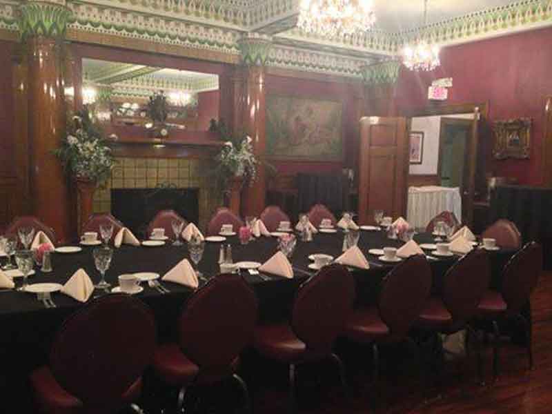 Corporate table place settings in black, white, and pink theme at The Corinthian Event Center.