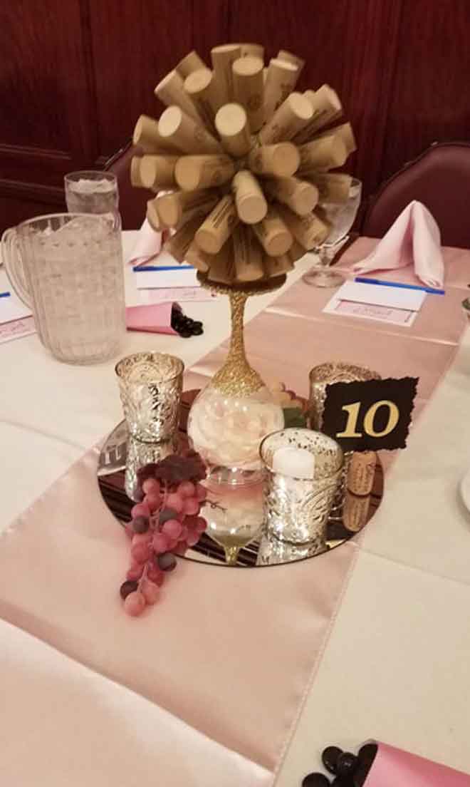 Corporate table centerpiece in white and pink theme at The Corinthian Event Center.